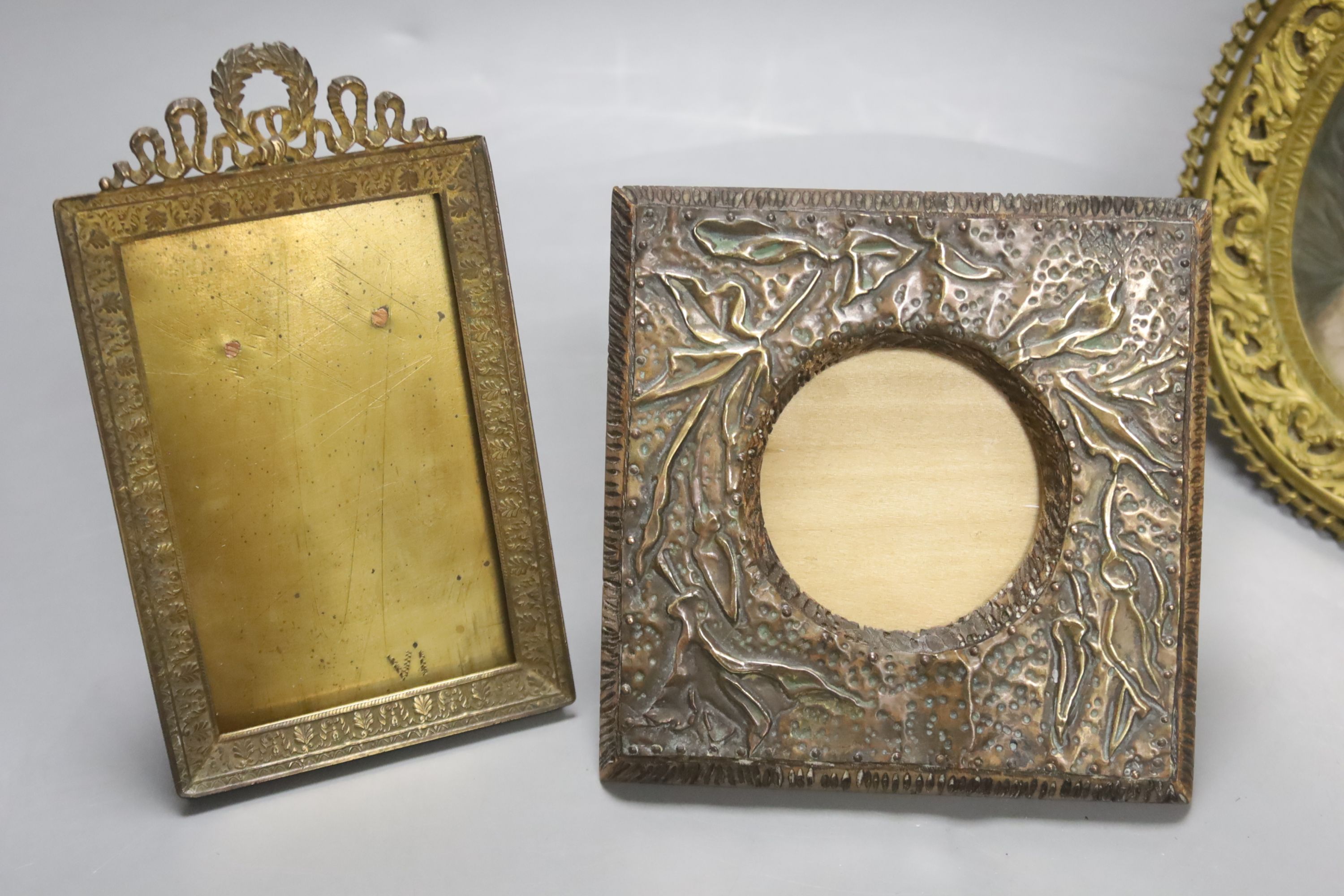 A Victorian framed miniature (snuff box lid) of children in a nursery, another miniature and three small frames, largest 10cm diameter